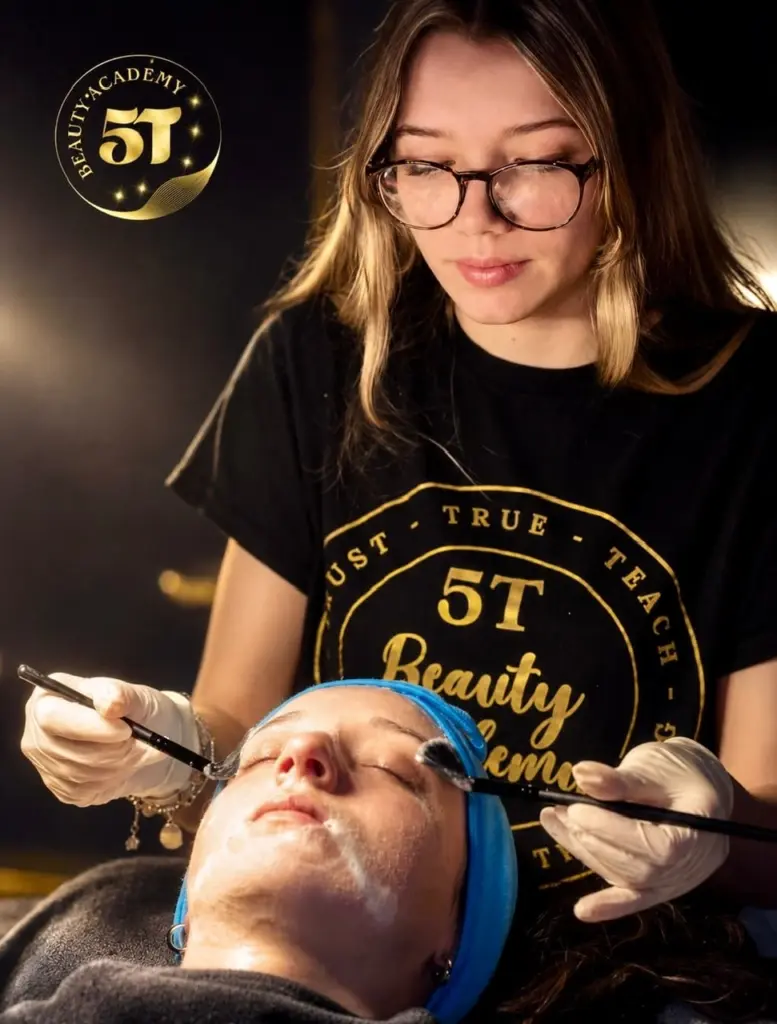 Esthetician student performing professional facial treatments during hands-on skincare training at 5T Beauty Academy
