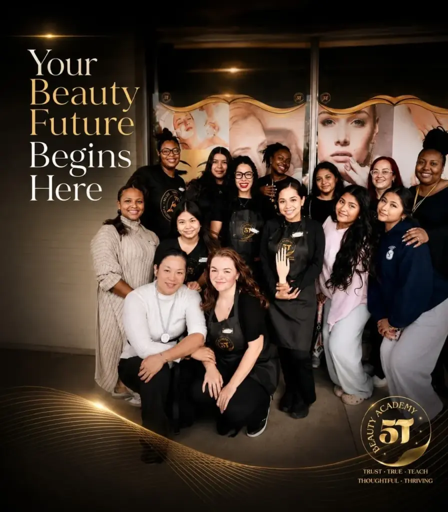 A diverse group of students and instructors posing together outside 5T Beauty Academy.