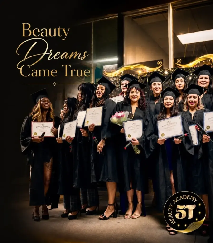 A large group of diverse female graduates in black caps and gowns proudly holding their diplomas at the 5T Beauty Academy graduation ceremony.