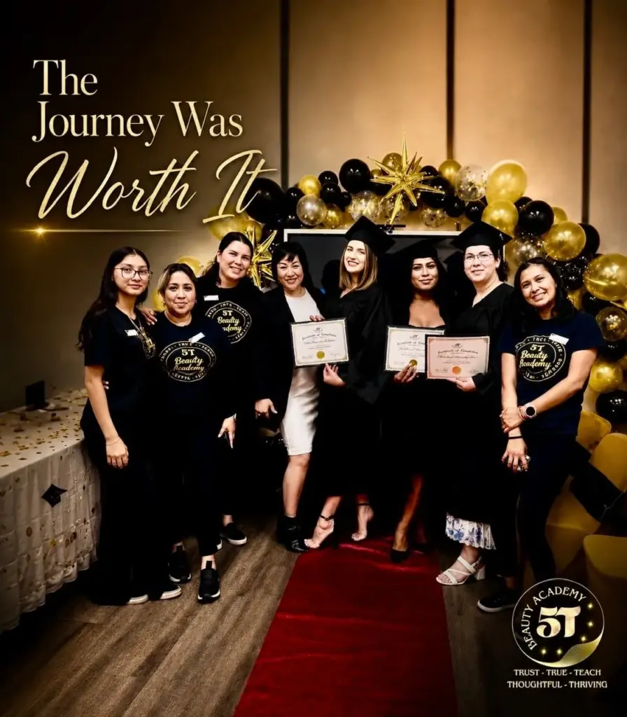Beauty school graduates proudly holding their certificates on the red carpet with their instructor