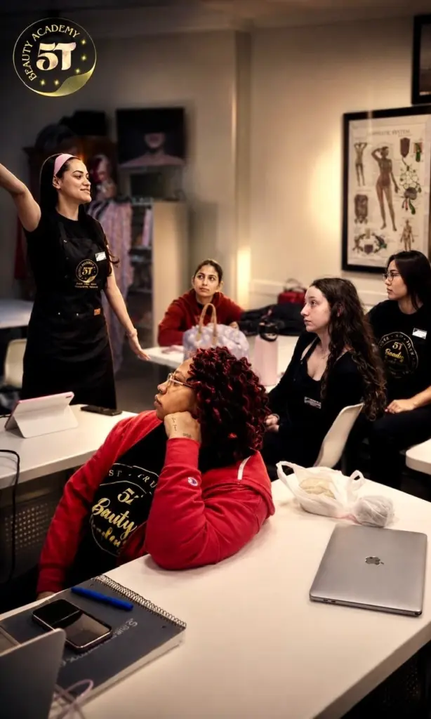 Beauty school students and instructors supporting each other in a collaborative learning environment at 5T Beauty Academy.